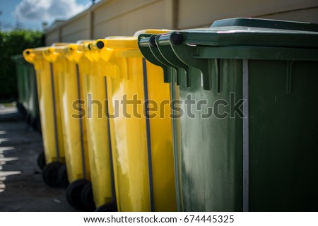 Trash bin with wheel and hand grip Royalty-Free Stock Photo #674445325