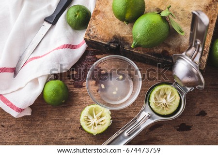 still life of green lemon on wooden background