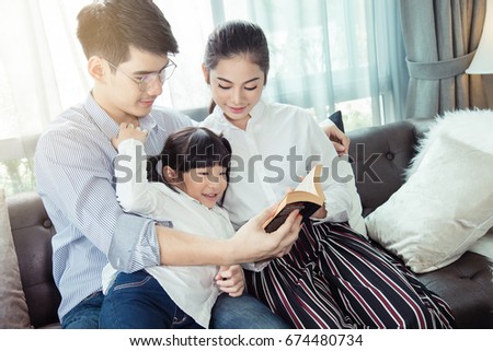 Father and mother Teaching children to do their homework at home,Asian family is happy