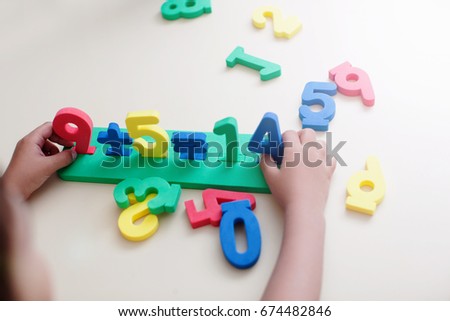 Little Boy Playing with figures, early education, Mathematics and numeracy. Top view no face               