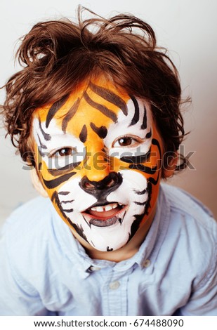 little cute boy with faceart on birthday party close up, little 