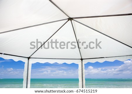 White tent with sea background