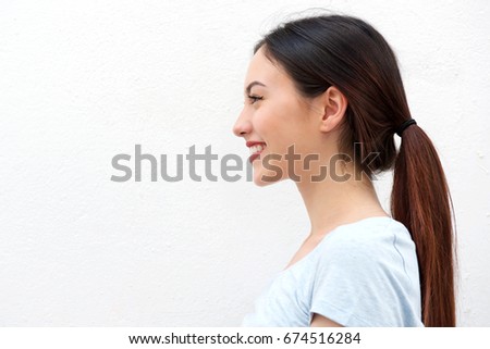Close up side portrait of healthy young woman with long hair smiling Royalty-Free Stock Photo #674516284