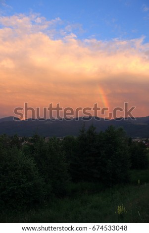Sunset over the mountains with rainbow