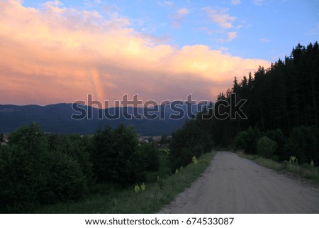 Sunset over the mountains with rainbow
