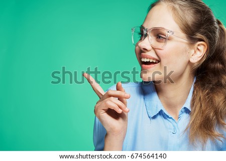 Woman in glasses on a green background                               
