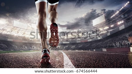 Sports background. Runner feet running on stadium closeup on shoe. Dramatic picture. Royalty-Free Stock Photo #674566444