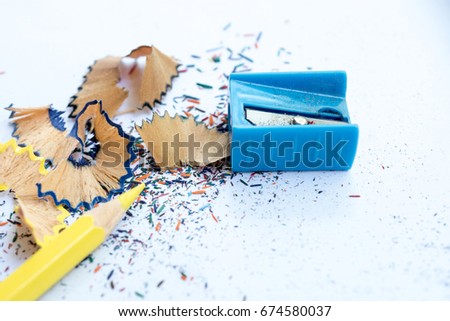 color pencil with sharpening shavings on white background
