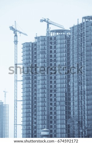 Color image of some cranes building a new structure.