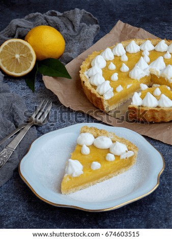 Lemon tart pie with meringue cream. Homemade cake on grey background
