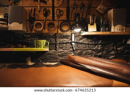 Picture of instruments on wooden wall at footwear workshop.