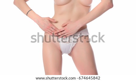 pretty woman in panties showing pain in her abdomen. on white background