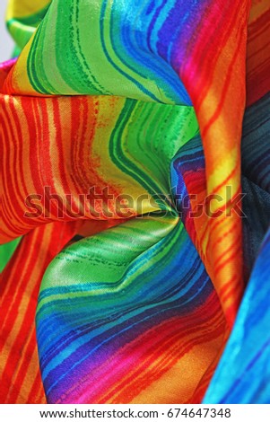 Silk dress material cloth texture pattern. 
tailoring stitching concept. Shiny beautiful fashion fabric. Shiny clothing material sample.Creased rainbow fabric.