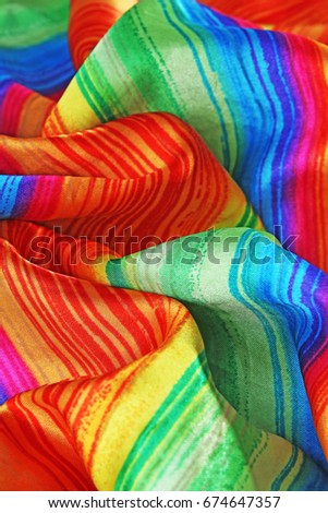 Silk dress material cloth texture pattern. 
tailoring stitching concept. Shiny beautiful fashion fabric. Shiny clothing material sample.Creased rainbow fabric.