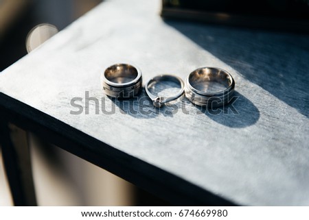 wedding rings on texture background, wood