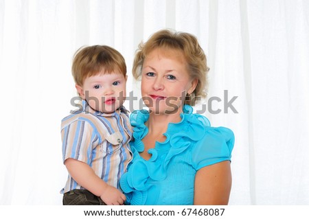 Grandmother and grandson spend time together. Symbol of the family.