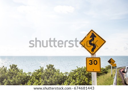 road sign over blurred seascape background.