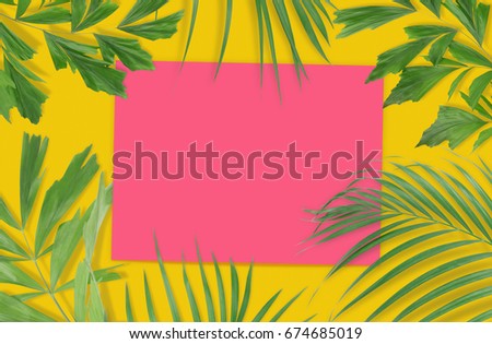 Tropical palm leaves with empty paper for your design on yellow background. Minimal nature. Summer Styled.  Flat lay. High resolution 5500 x 3600 pixels in size.