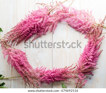  frame made with beautiful pink flowers on wooden background, copyspace, flat lay