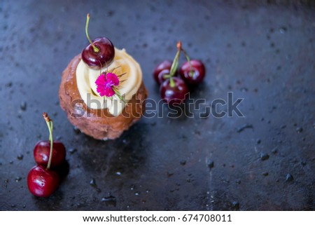 chocolate cake with cherries and edible flowers