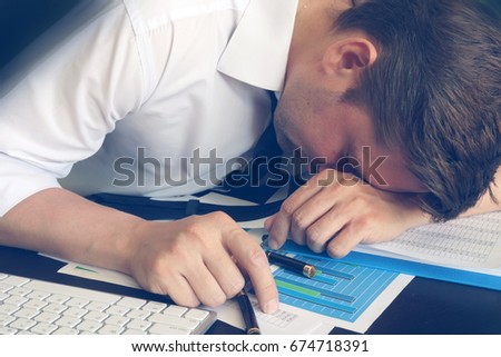 Chronic fatigue syndrome concept. Overworked businessman is sleeping at desk. Royalty-Free Stock Photo #674718391
