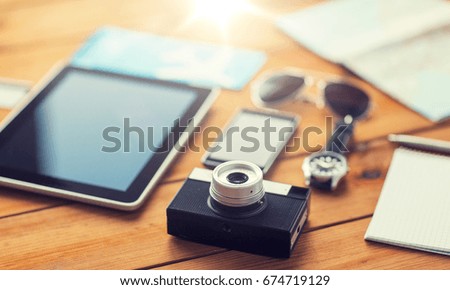 travel, tourism, technology and objects concept - close up of retro film camera, gadgets and personal stuff