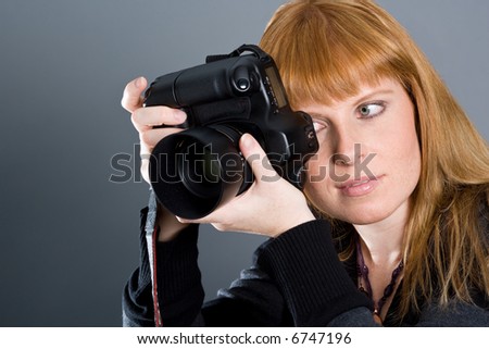 Woman photographing with professional camera 2