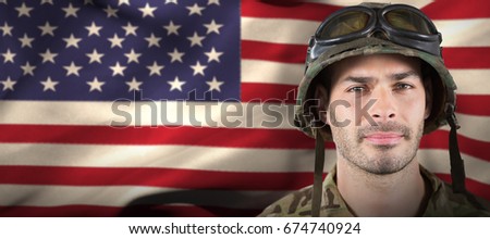 Close up of handsome soldier against waving american flag