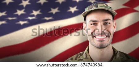 Close up of smiling soldier against waving flag of america