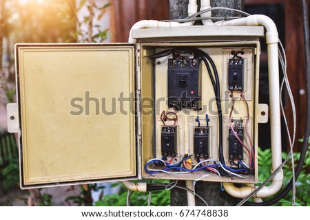 Electric system in cabinet building system. The circuit old breakers in Control box. Old electric panel.Electrical switchboard on the wall. Outdated power supply.Switch for turn on and off lights.