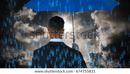 Rear view of businessman carrying blue umbrella  against dark sky with white clouds