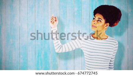 Thoughtful young woman gesturing  against wooden planks