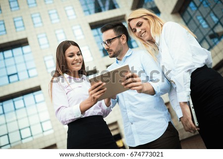 Picture of young attractive business partners standing