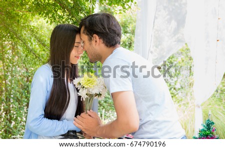 The first time of a lover couple in the garden, A picture of sweet couple .Amorous couple on romantic date in park, Age20-30 years.