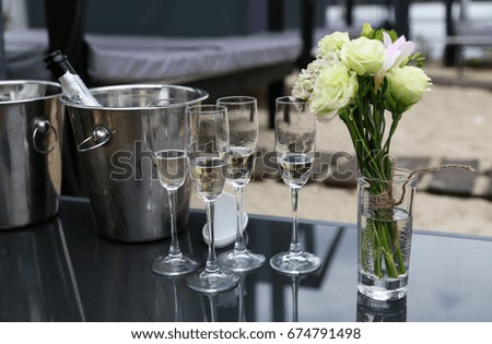 Glasses of champagne with flowers on the table