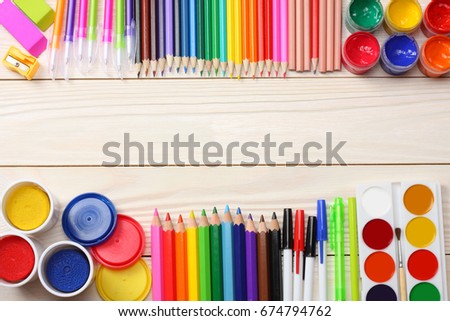 school and office supplies. school background. colored pencils, pen, pains, paper for  school and student education on white wooden background. top view with copy space