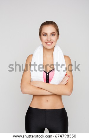 Beautiful young sport woman with towel. Confident fitness girl posing, healthy lifestyle concept