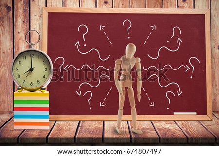 3d composite of tired wooden figurine against  composite image of black board Composite image of black board against wooden planks 