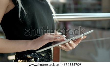 young female passenger at the airport using her tablet computer while waiting for flight, beautiful girl woman in shopping mall