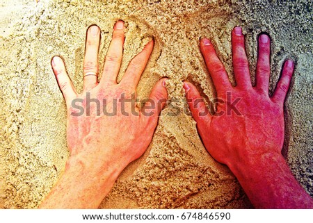 Film grain effect. Male hand in the salt sand on the beach.