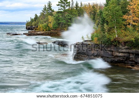 Crashing waves break against a rocky shoreline at Pictured Rocks National Lakeshore  in the Upper Peninsula of Michigan
