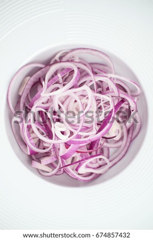 Sliced onion in a white plate close-up.

