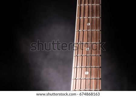 Acoustic Guitar neck on black background with copy space