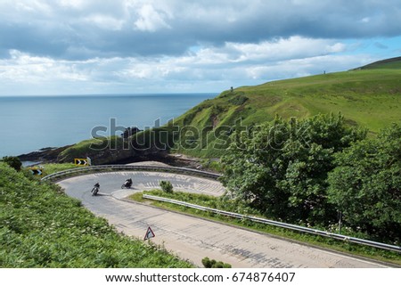 A couple of motorbikes navigate the Berriedale Braes hairpin - part of the North Coast 500 scenic route around the north coast of Scotland.