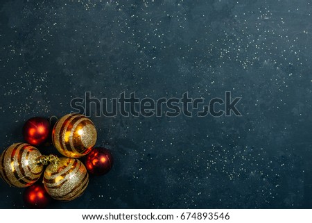Colourful traditional Christmas decoration on black chalkboard texture of old weathered boards with copyspace
