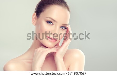 Beautiful Young Woman with Clean Fresh Skin . Facial  treatment   . Cosmetology , beauty  and spa . Royalty-Free Stock Photo #674907067