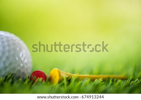 golf ball and tee on fairway