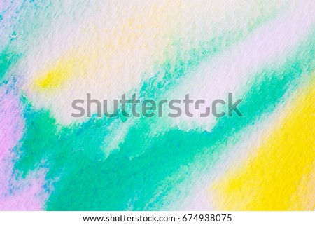 Colored watercolor paints on paper background