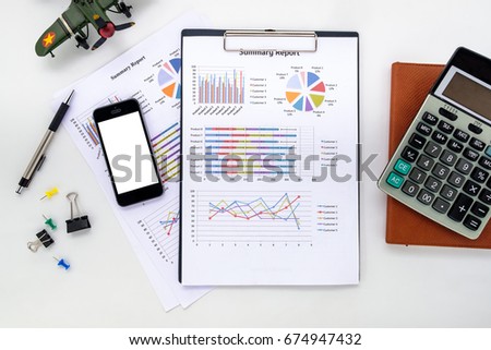 Modern white Office desk table with blank screen smart phone,pen,analysis chart and calculator .Top view Business analysis and strategy concept.