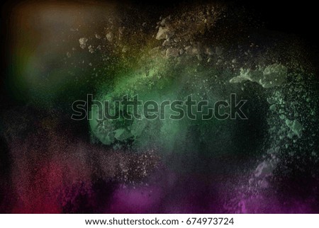 abstract powder splatted background. multicolor powder explosion on black background. Colored cloud. Colorful dust explode. Paint Holi.  